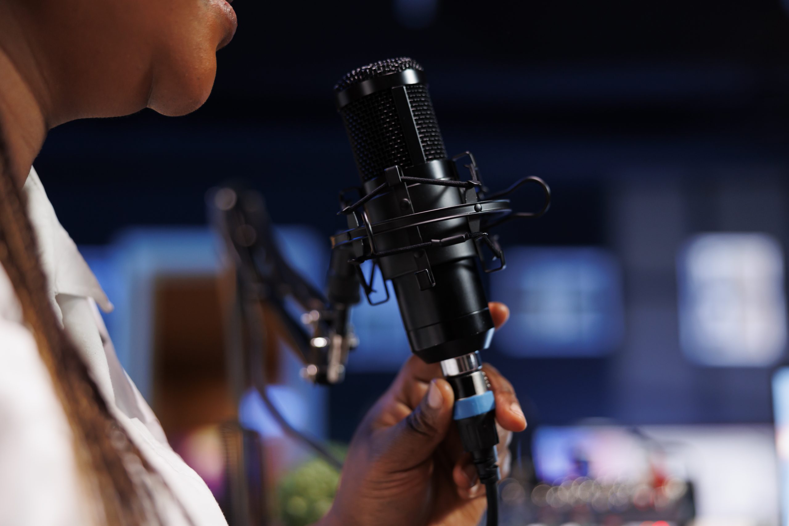 Black woman using podcast microphone